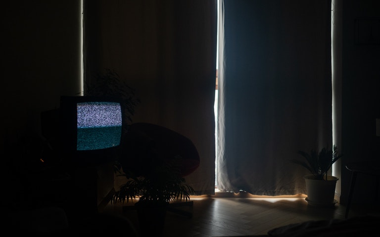 TV in a darkened room playing static